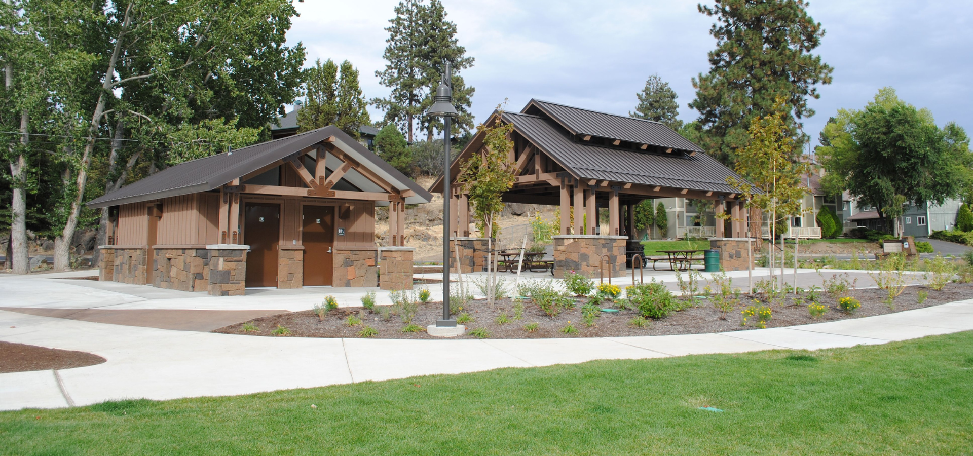 Miller's Landing picnic shelter and bathroom with lawn in the foreground