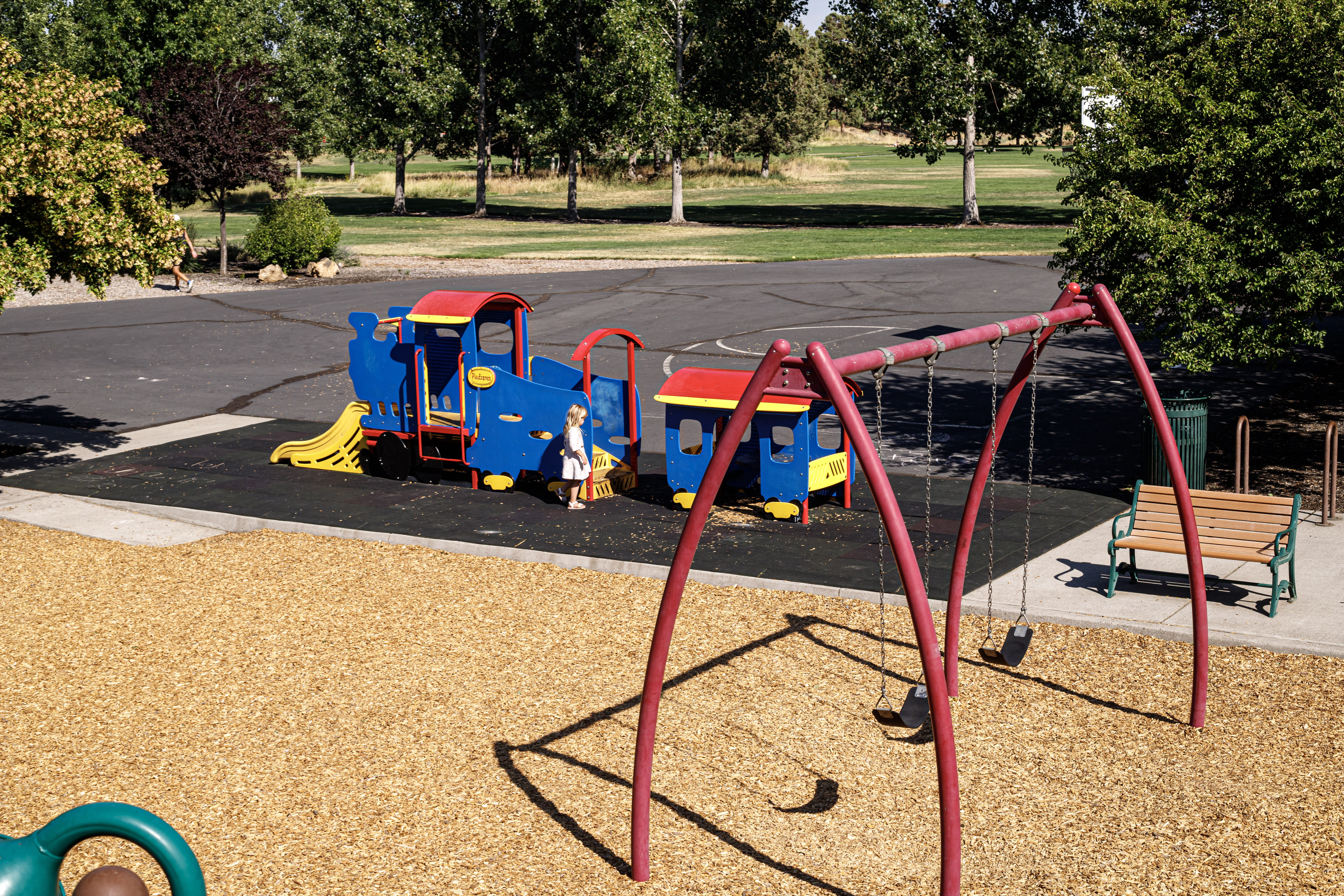 a view of the tot train and swings at al moody park