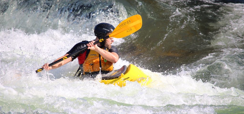 a whitewater kayaker at the bend whitewater park.