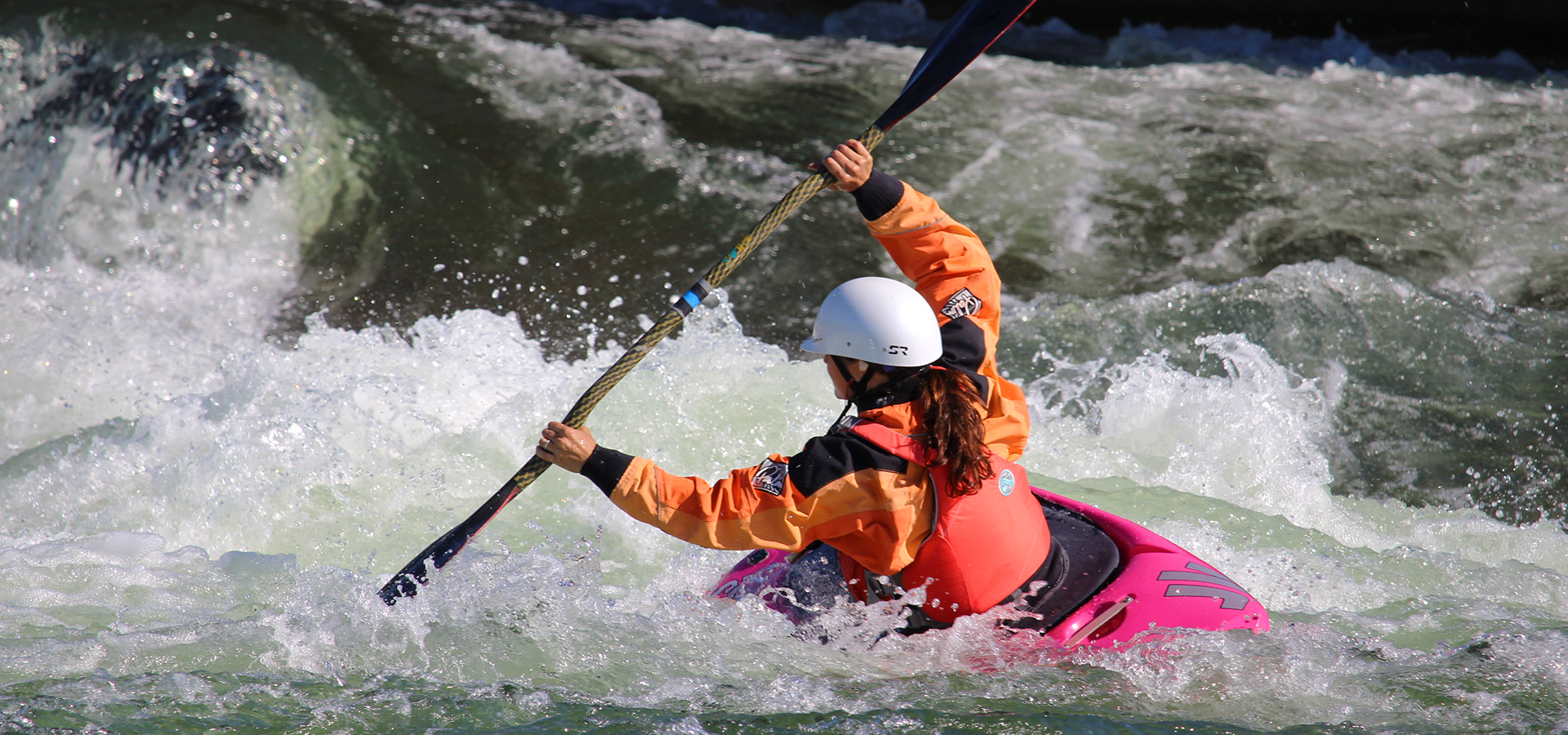 a whitewater kayaker at Bend Whitewater Park.