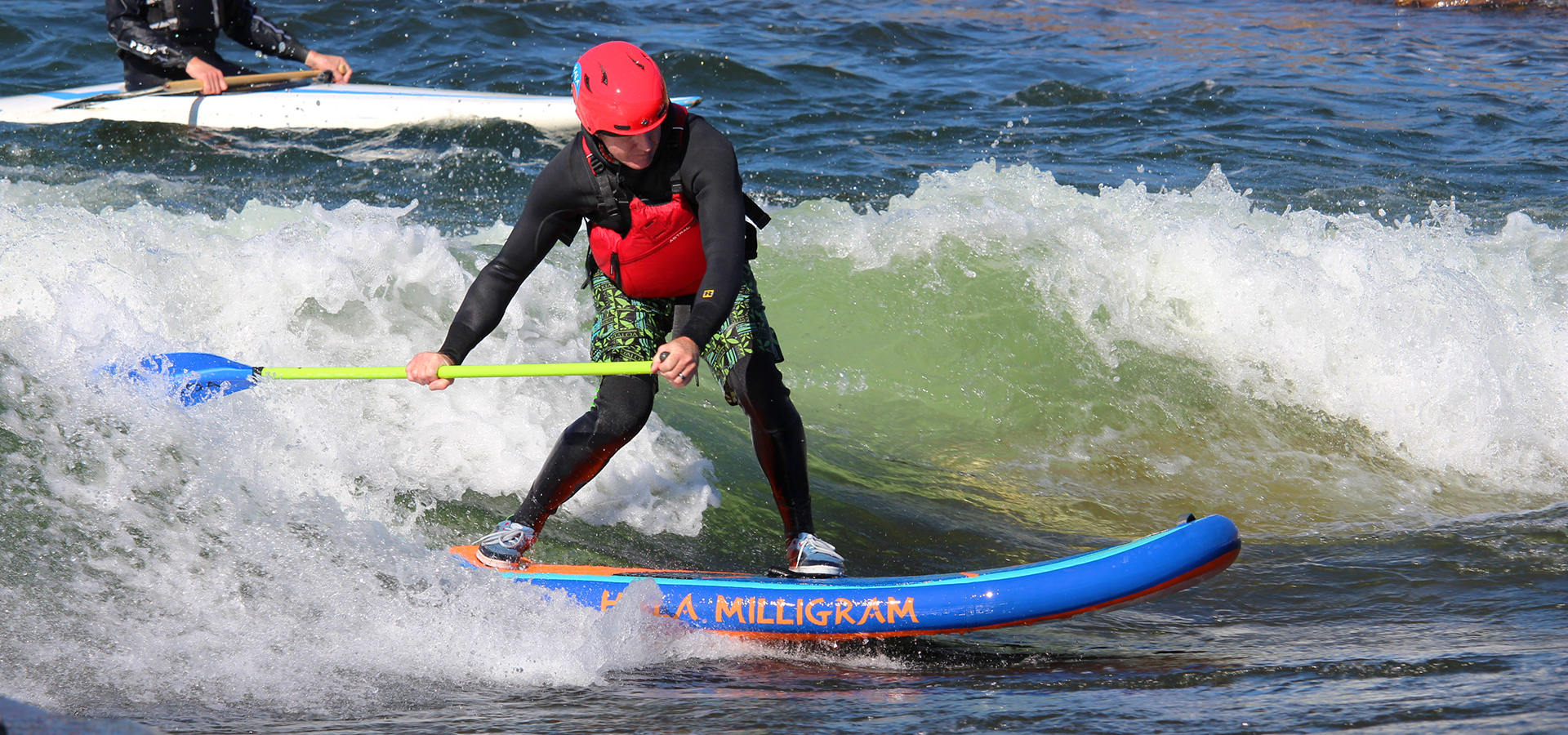 A paddleboarder at the bend whitewater park.