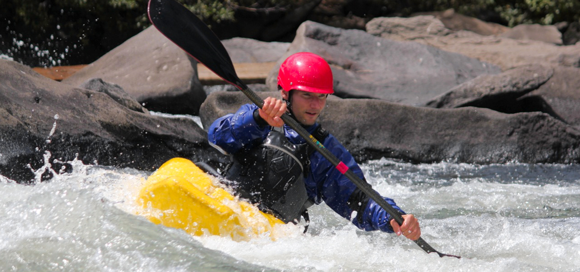 A kayaker in the river at First Street Rapids park.