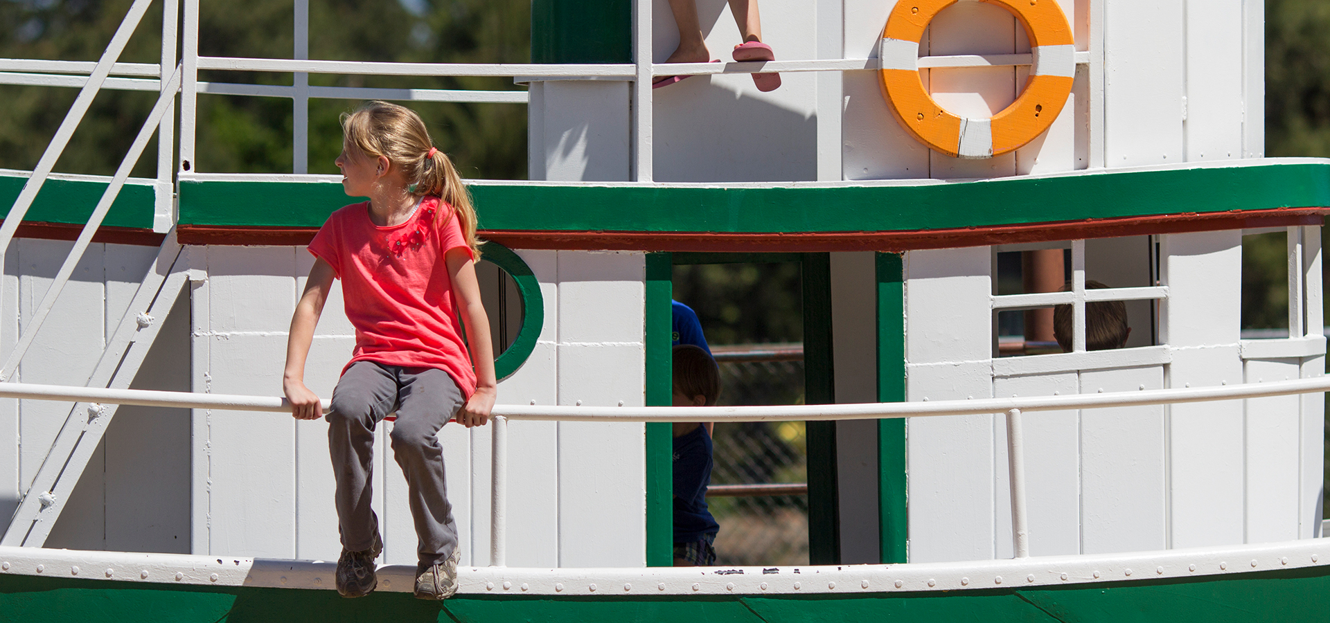 A child sitting on the boat at Harmon Park.