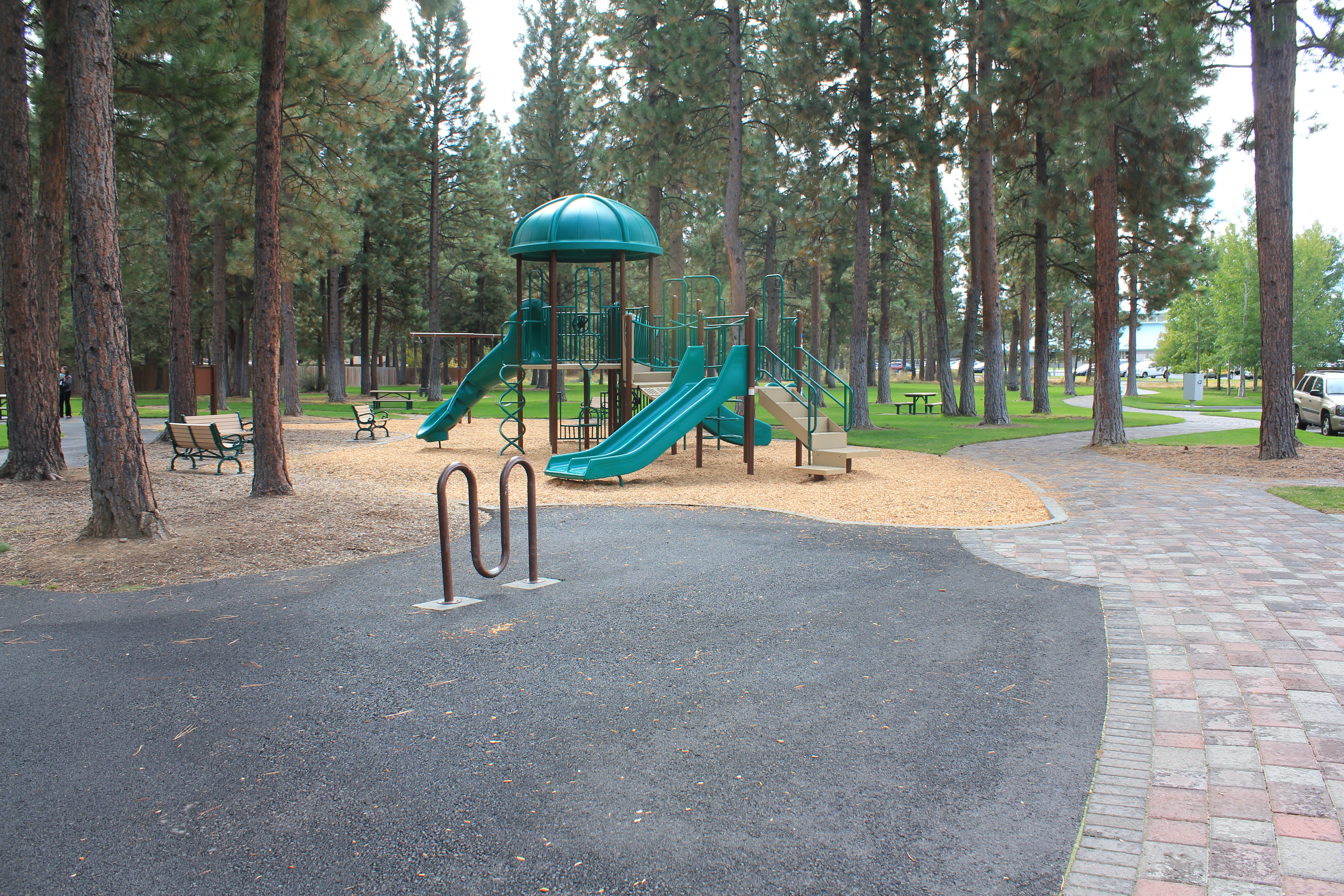 a bike rack and playground at hollygrape park
