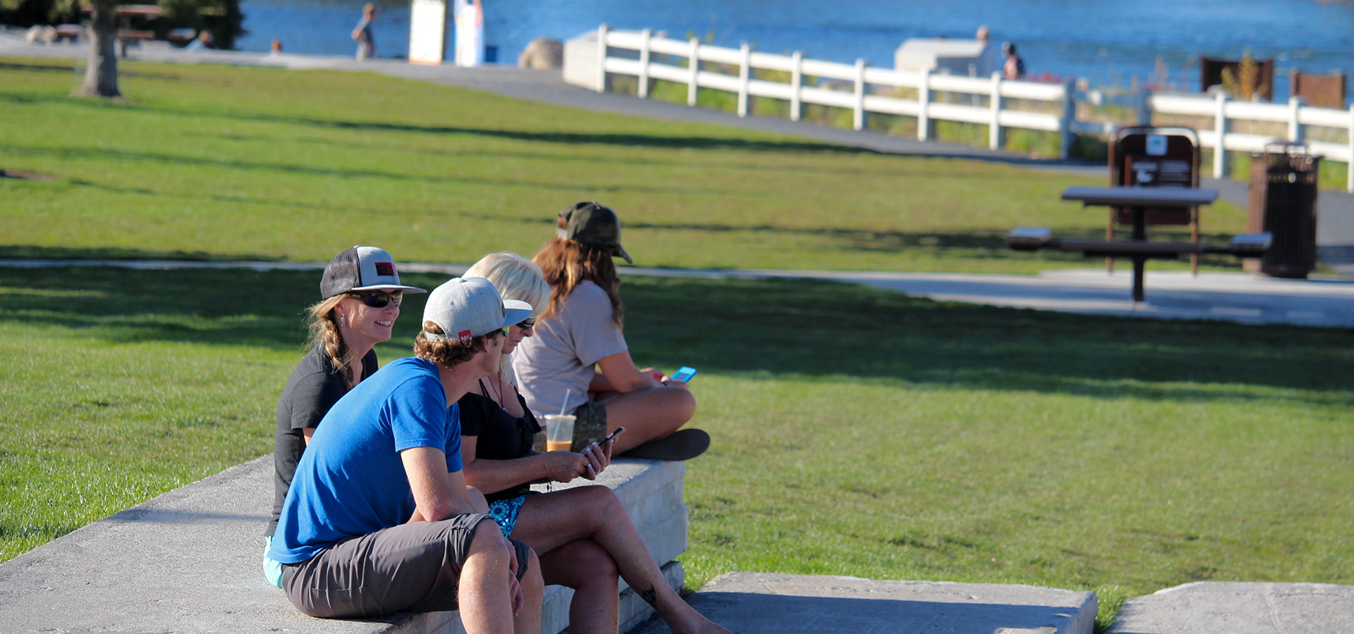 A group of people sitting down at McKay Park.