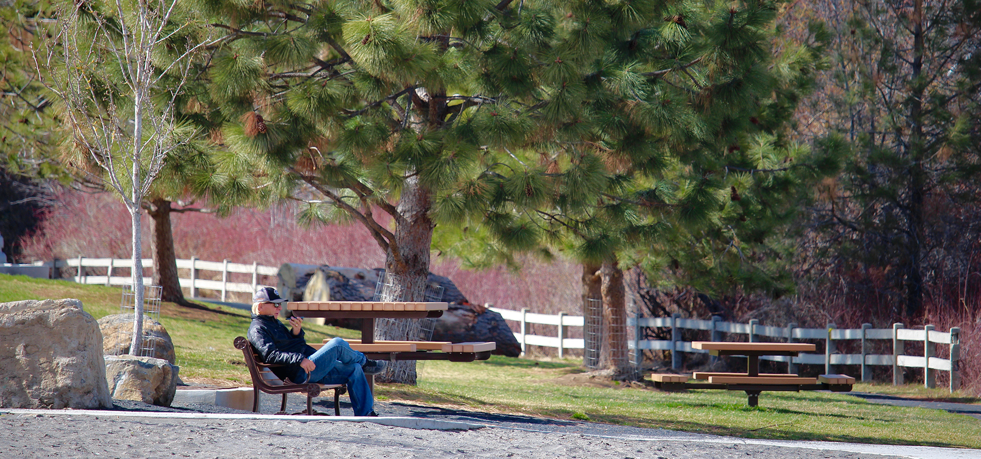 A man sitting on a bench at McKay Park.