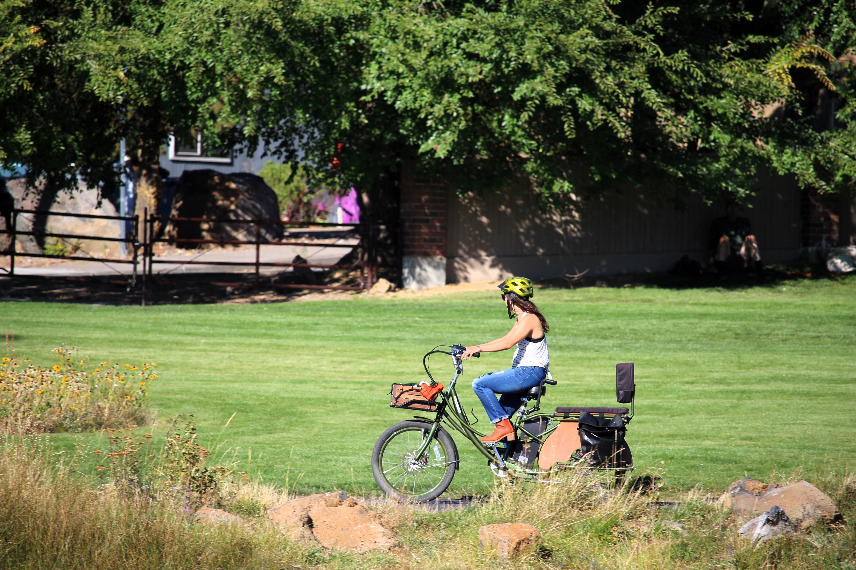 a patrons rides their bike on the trail through millers park