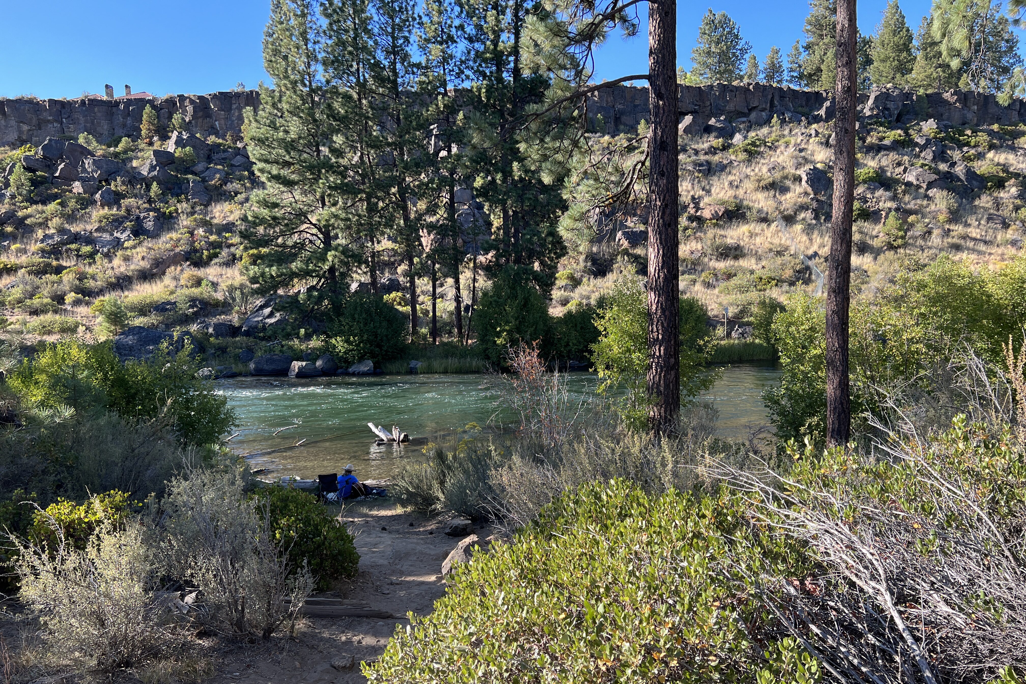 a person relaxing by the river at river rim