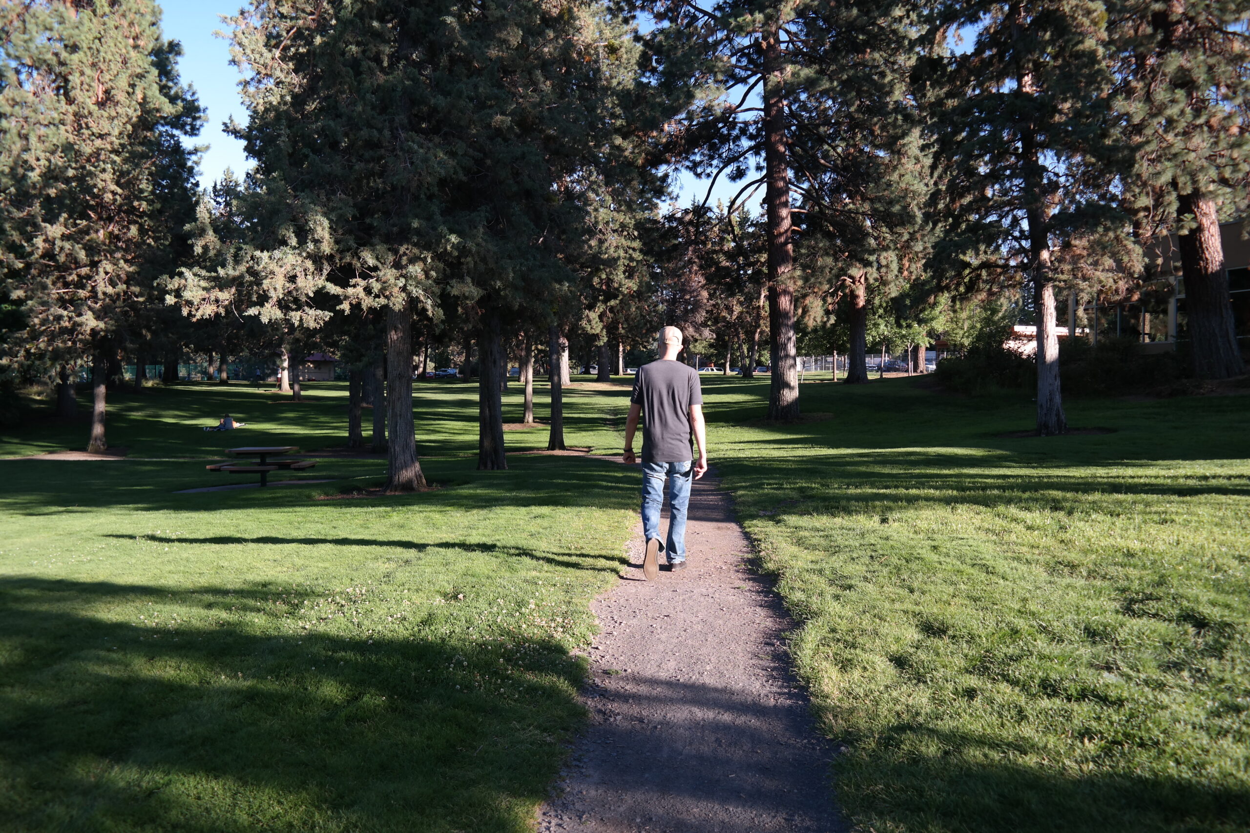 A man walking on a trail at Juniper Park.