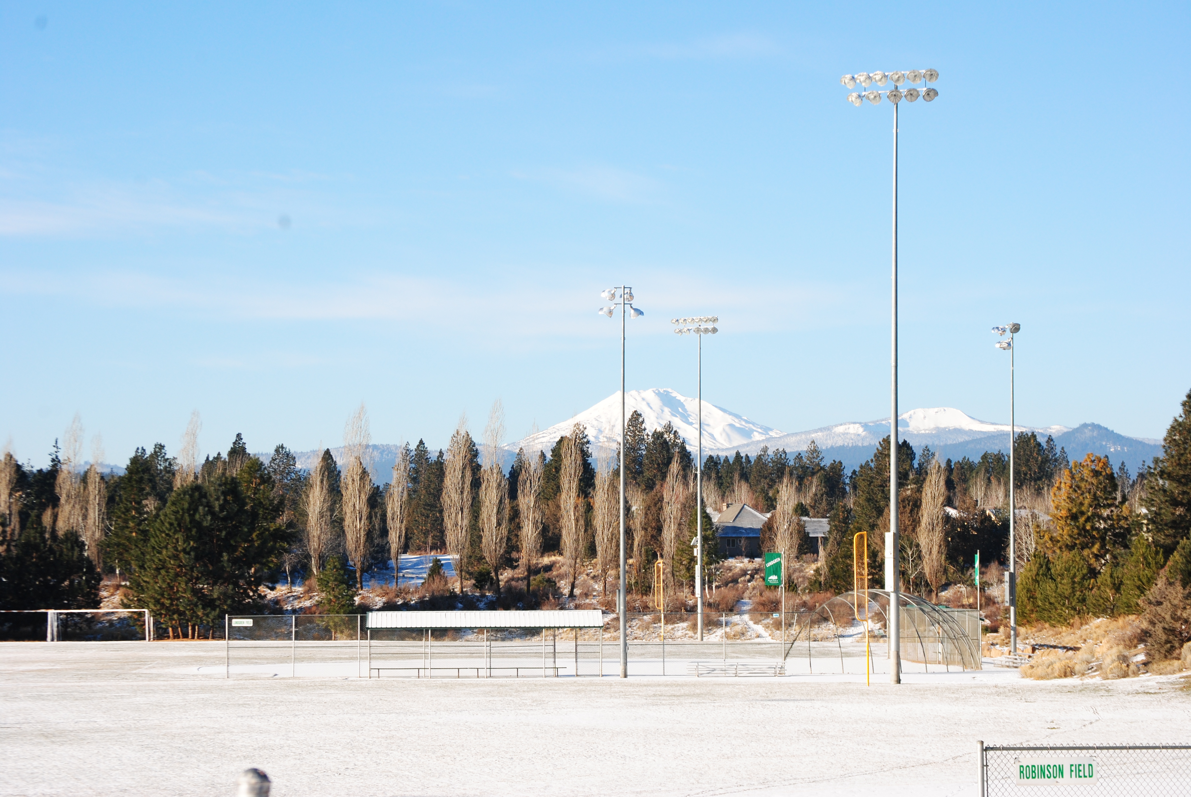 Photograph of Skyline Sports Complex with snow covered mountains in the background