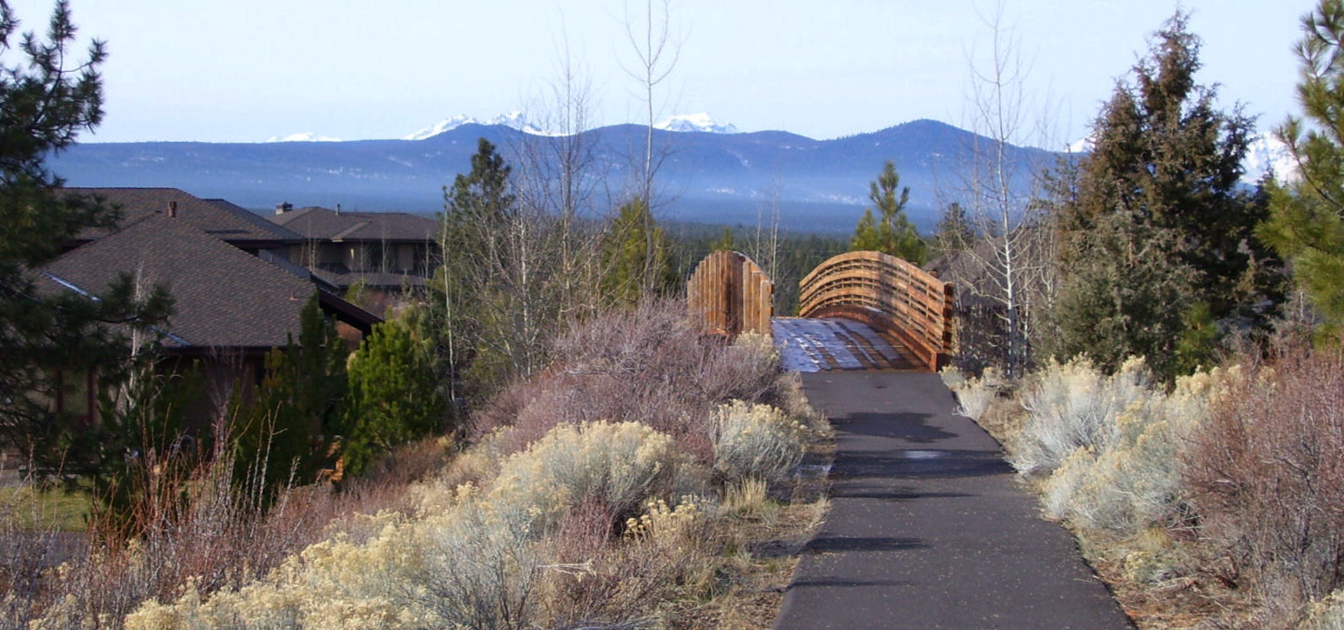 The trail and pedestrian bridge at Three Pines Park.