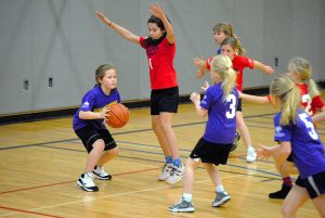 Girls playing a youth basketball game.