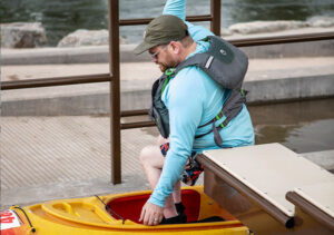 PAtron transfering from the bench to kayak on the roller ramp.