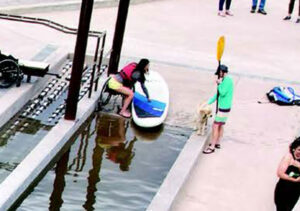 Image of patrons getting their kayak ready on the wet launch at Miller's Landing.