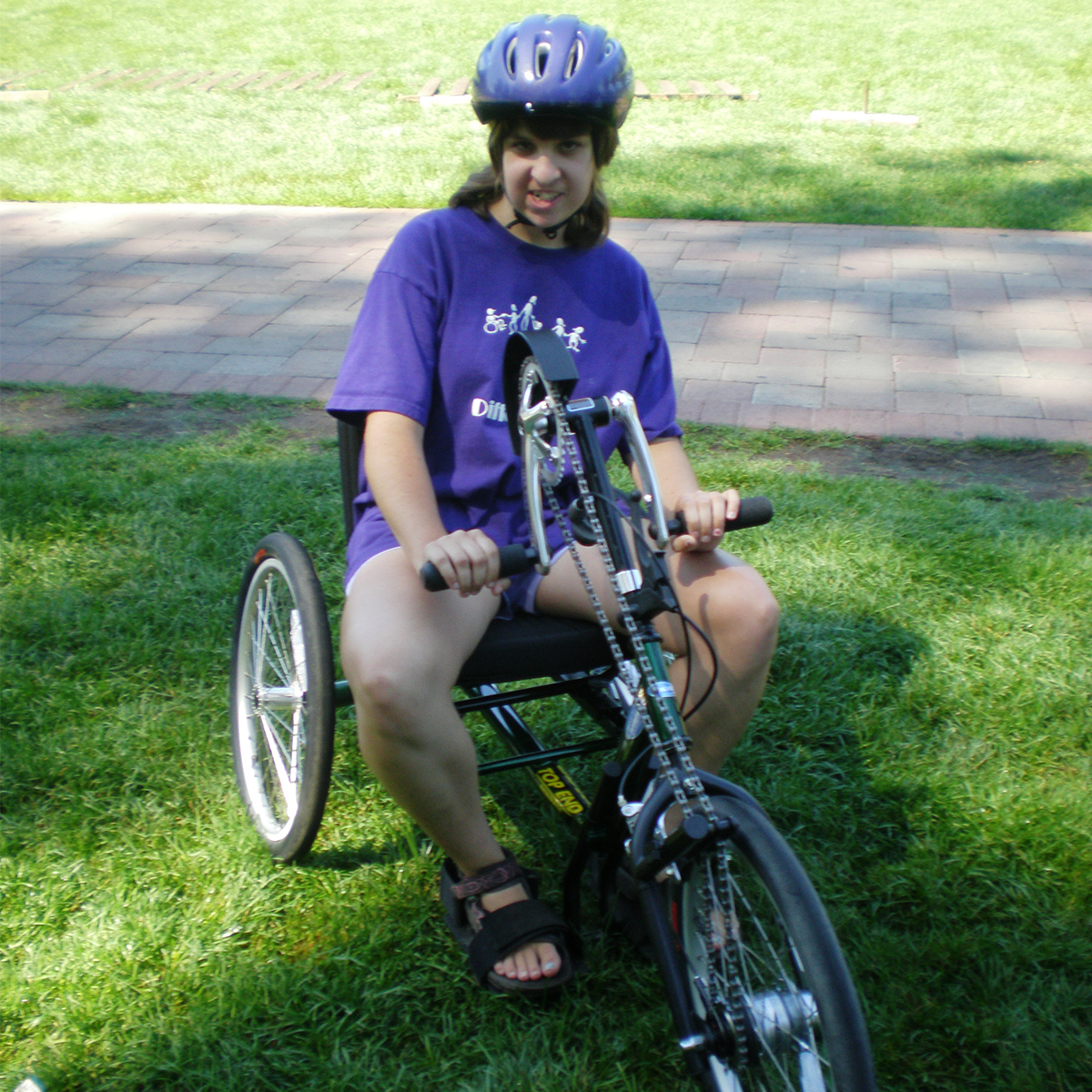 A girl on an recumbent bicycle.