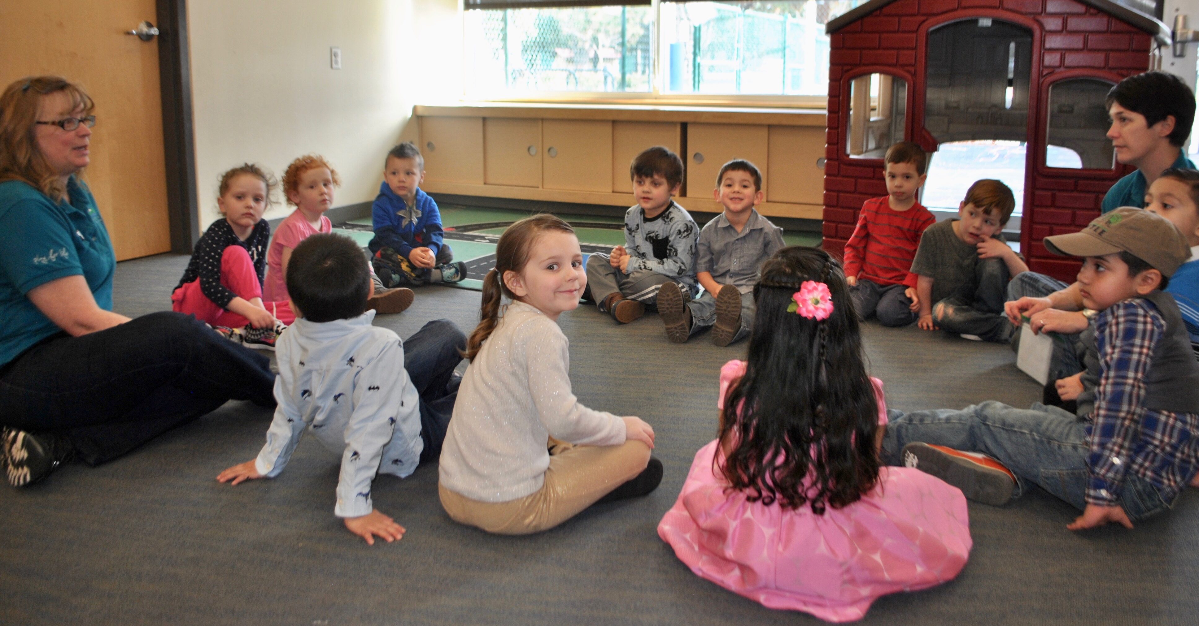 children sitting during story time at daycare