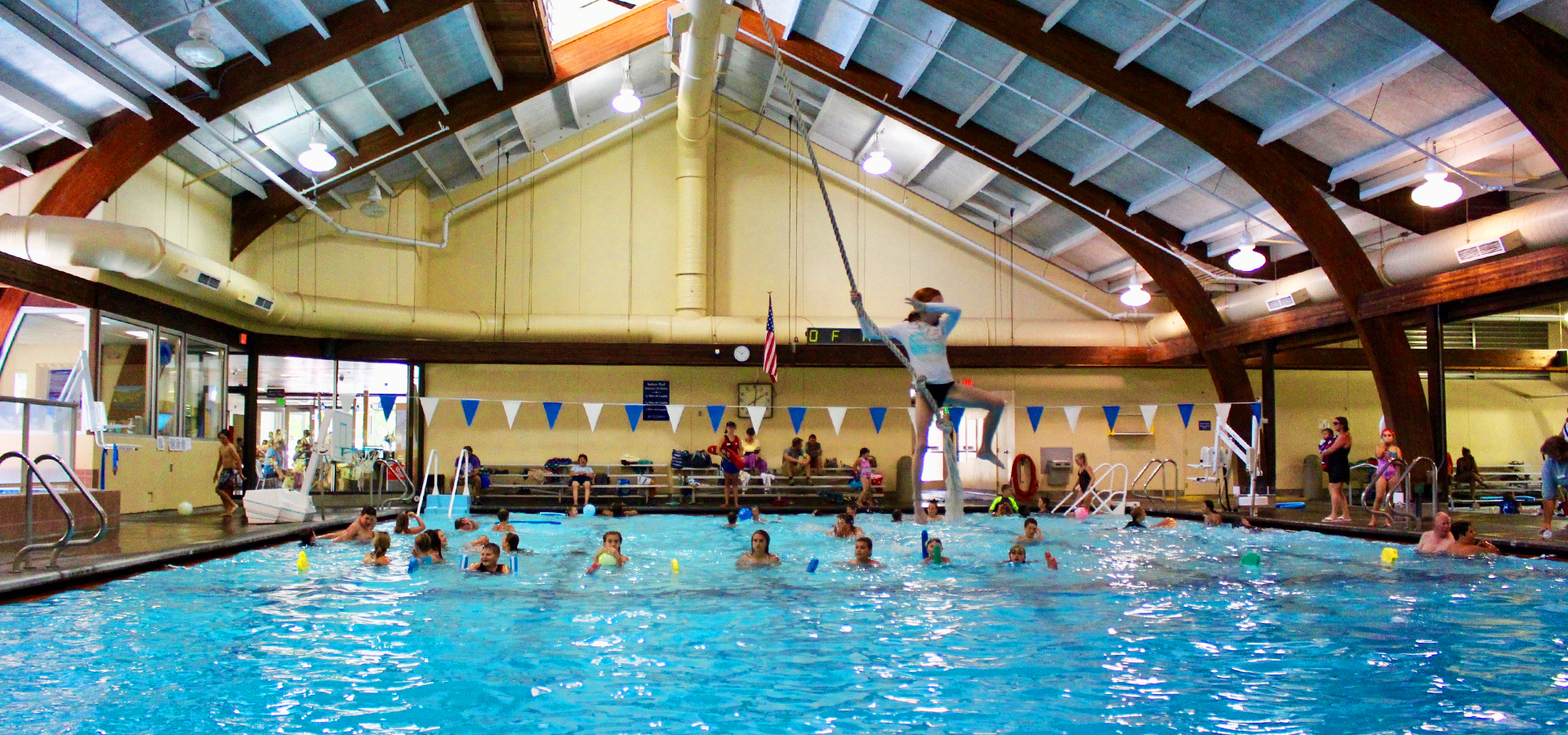 A kid jumping from a rope swing at Juniper.