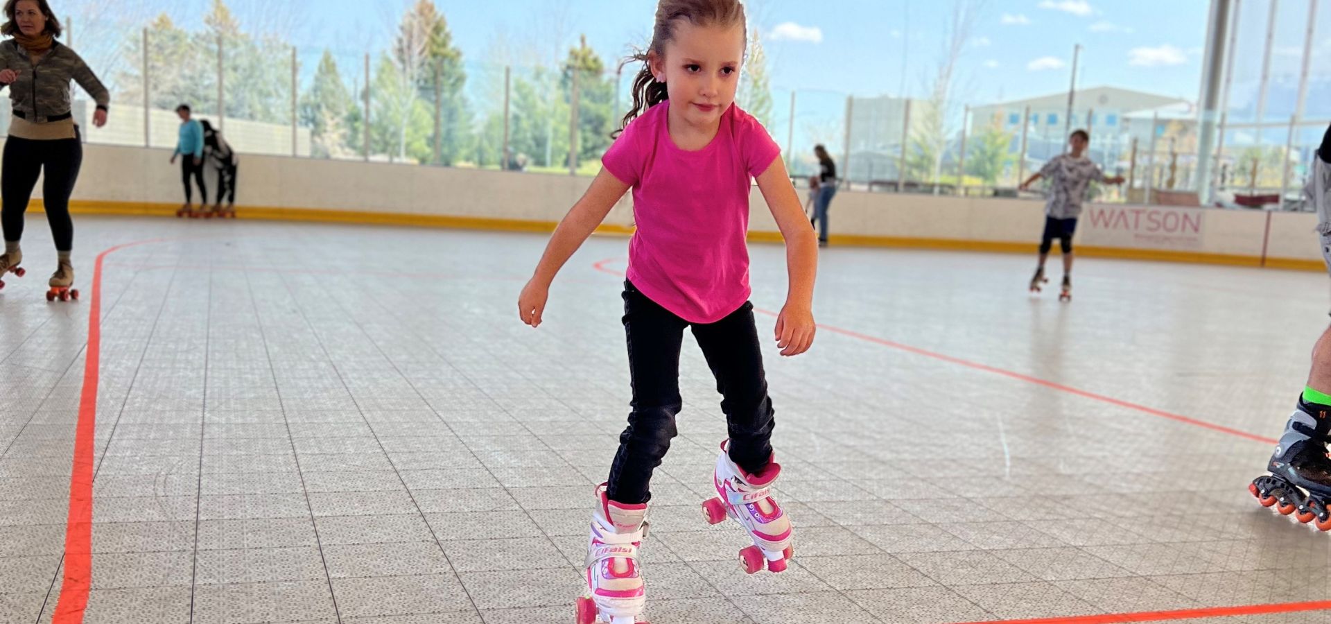 a little girl roller skating at the pavilion