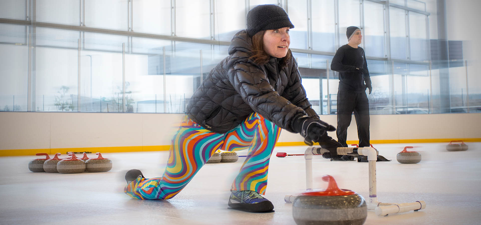 woman throwing a curling rock