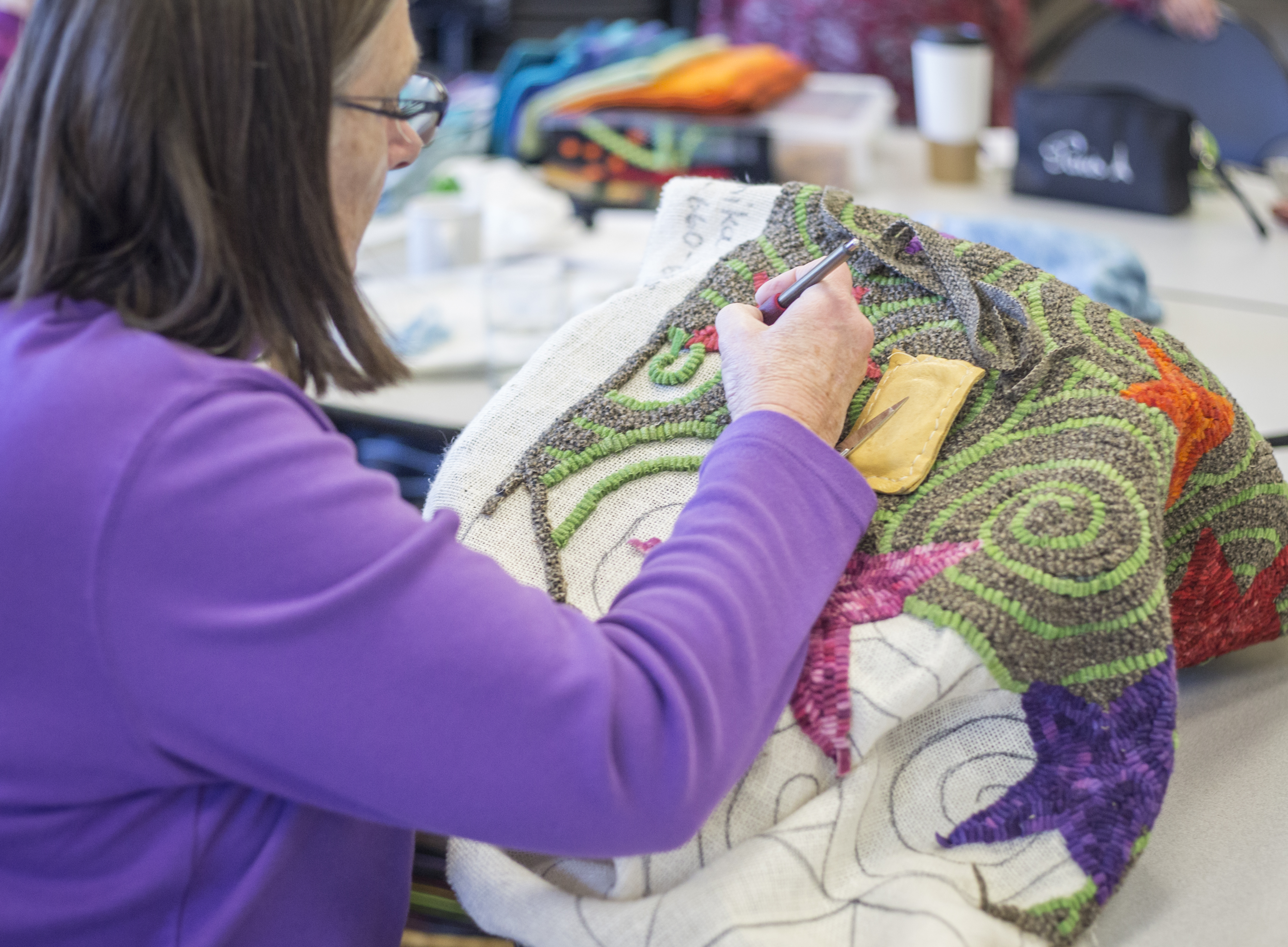 A woman embroiders at the Social activity at Bend Senior Center.