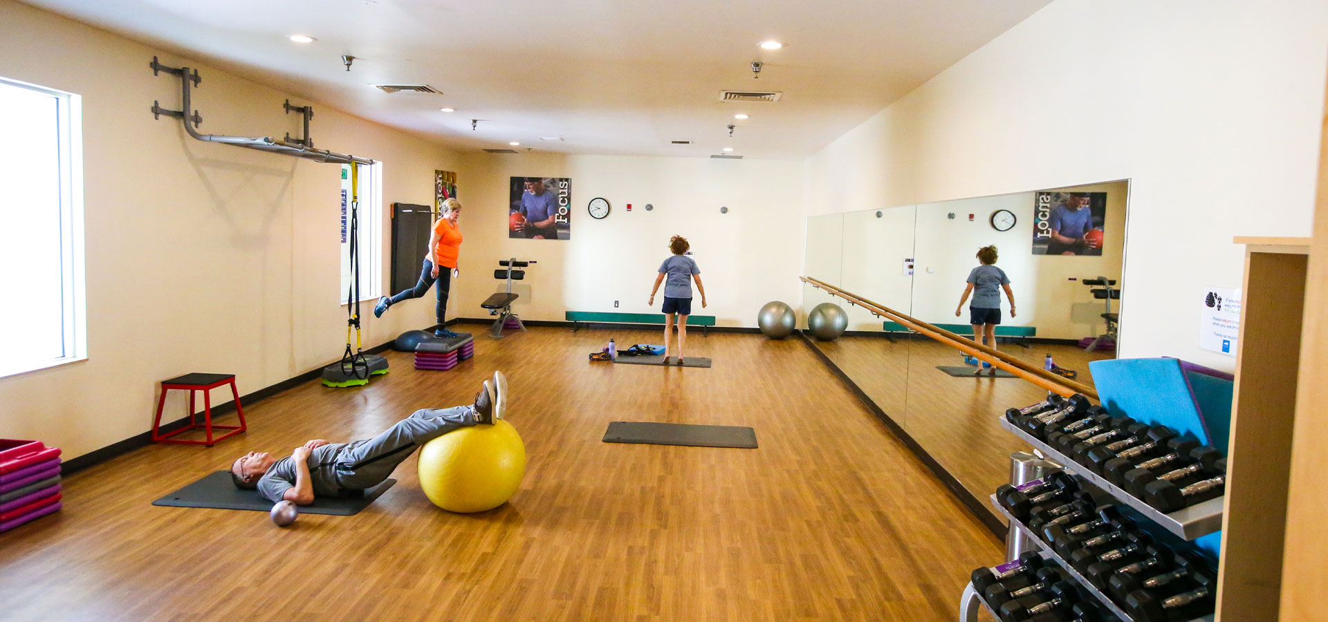 Three patrons doing fitness in the studio at Juniper