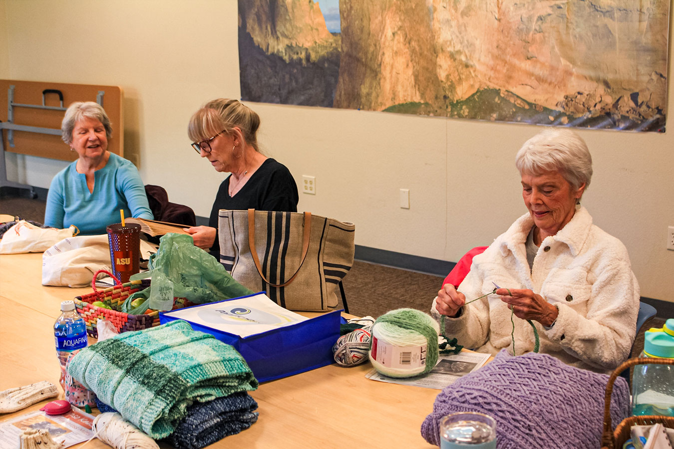 A group of women are knitting together at the Bend Senior Center