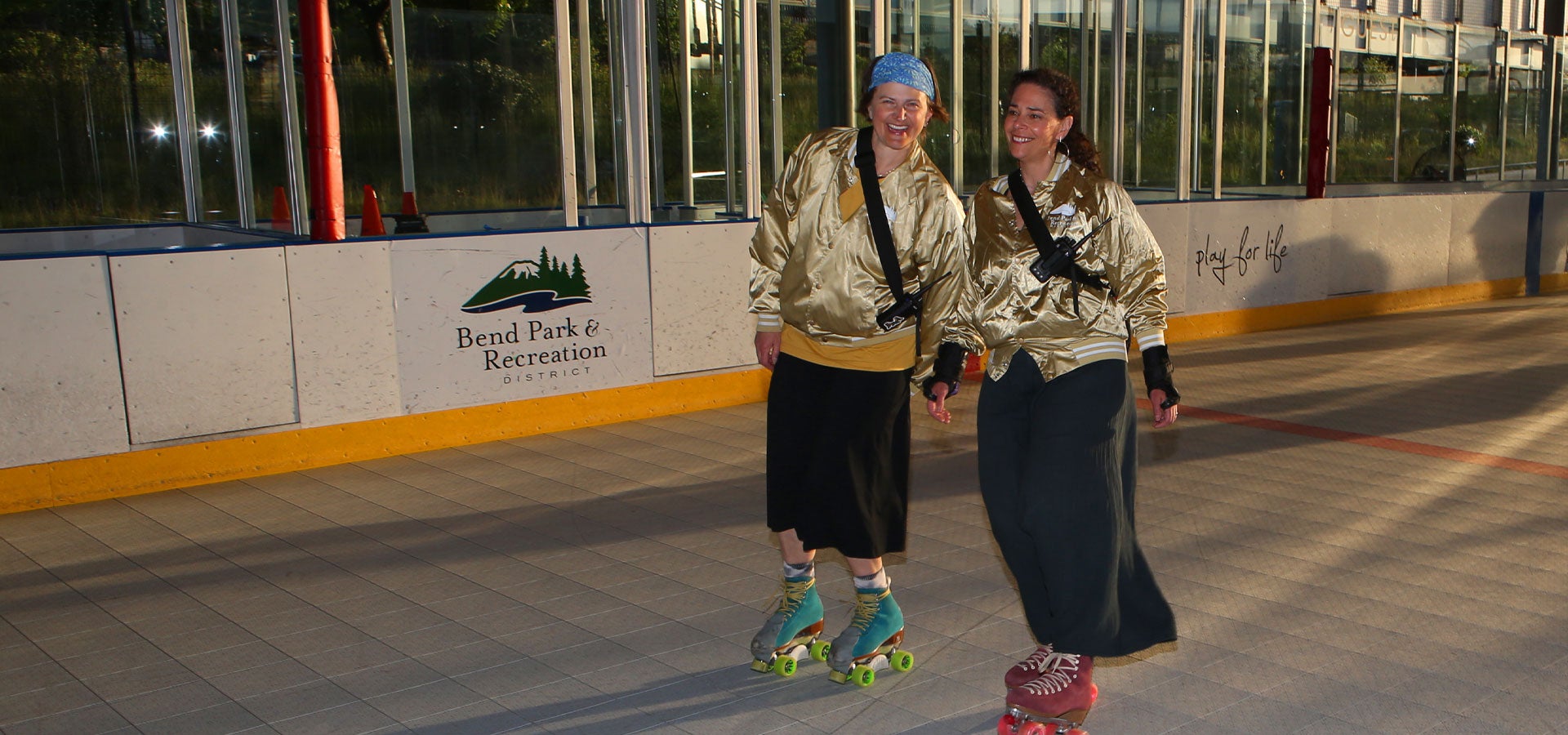Two Bend Park and Recreation District employees skate on the Pavilion during sunset
