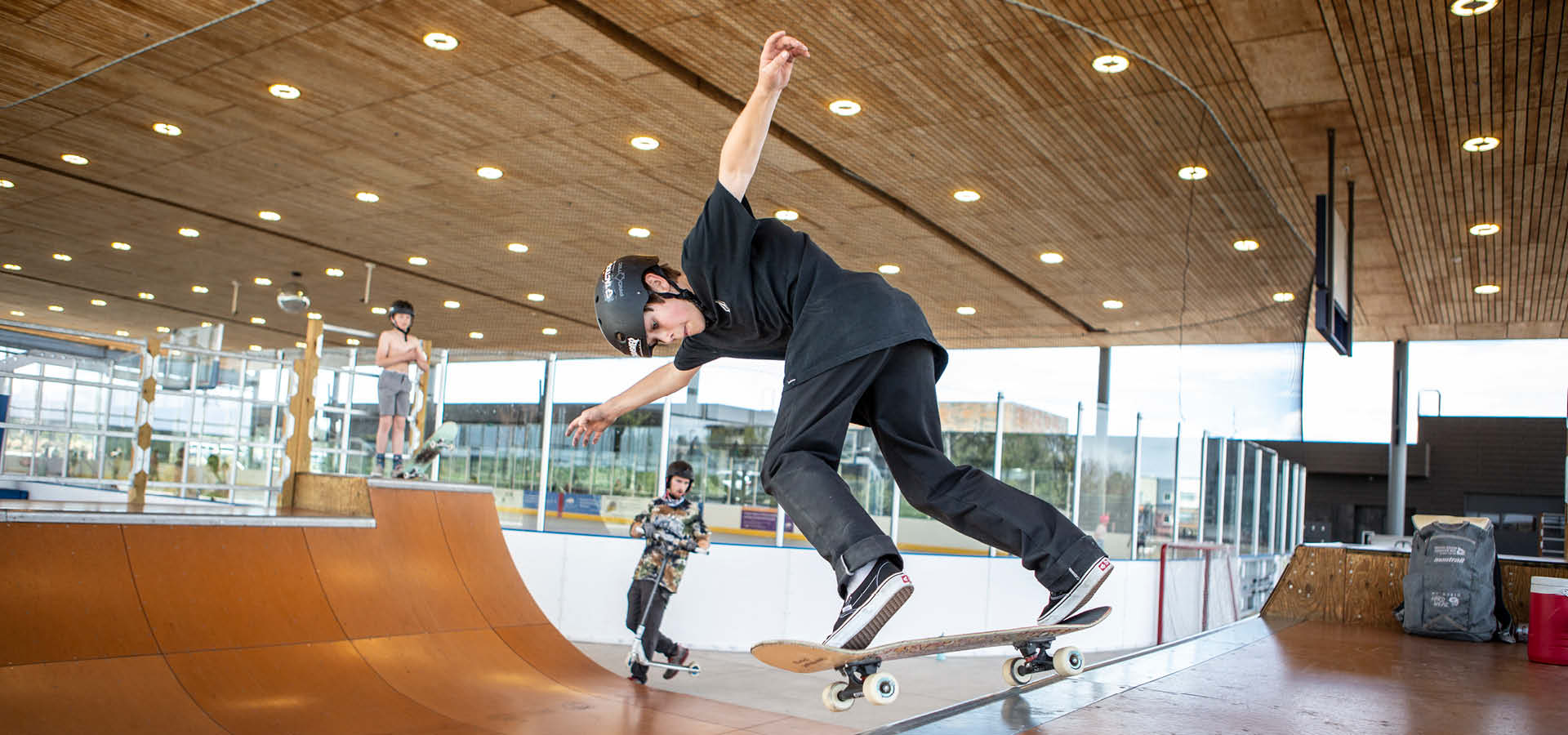 kid doing a skateboard trick on a half-pipe