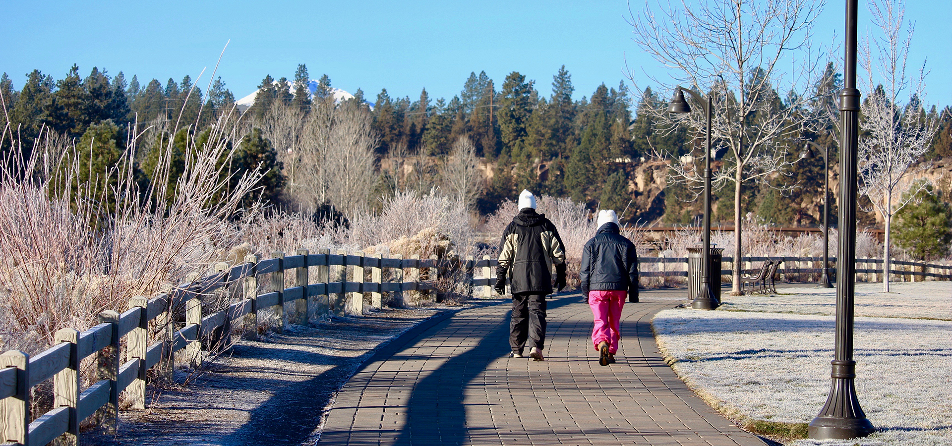 People walking at Riverbend Park on a frosty morning.