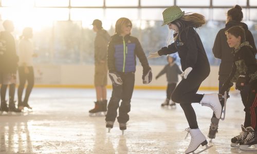 A group of kids ice skating at The Pavilion.