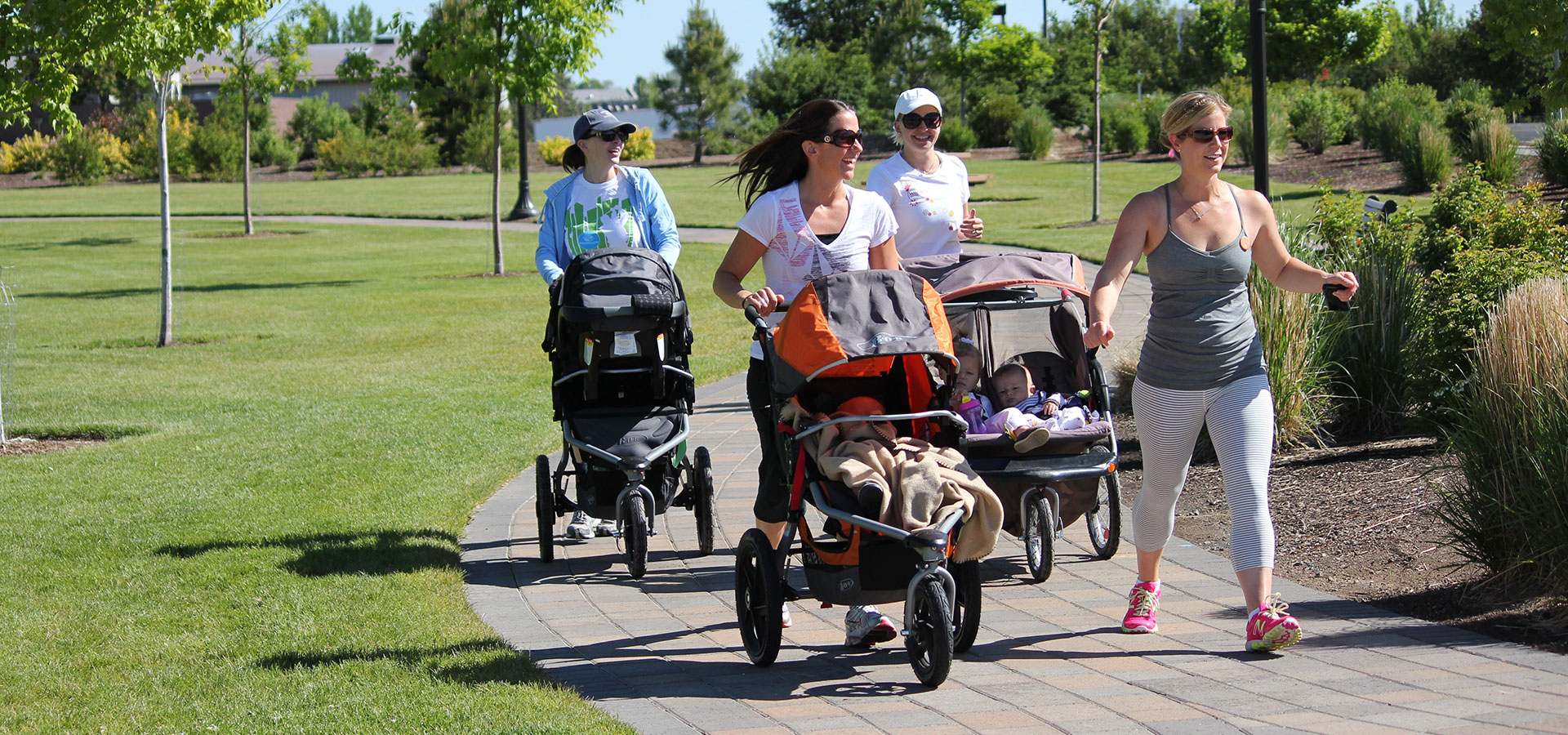 Women walking with strollers at Riverbend Park.