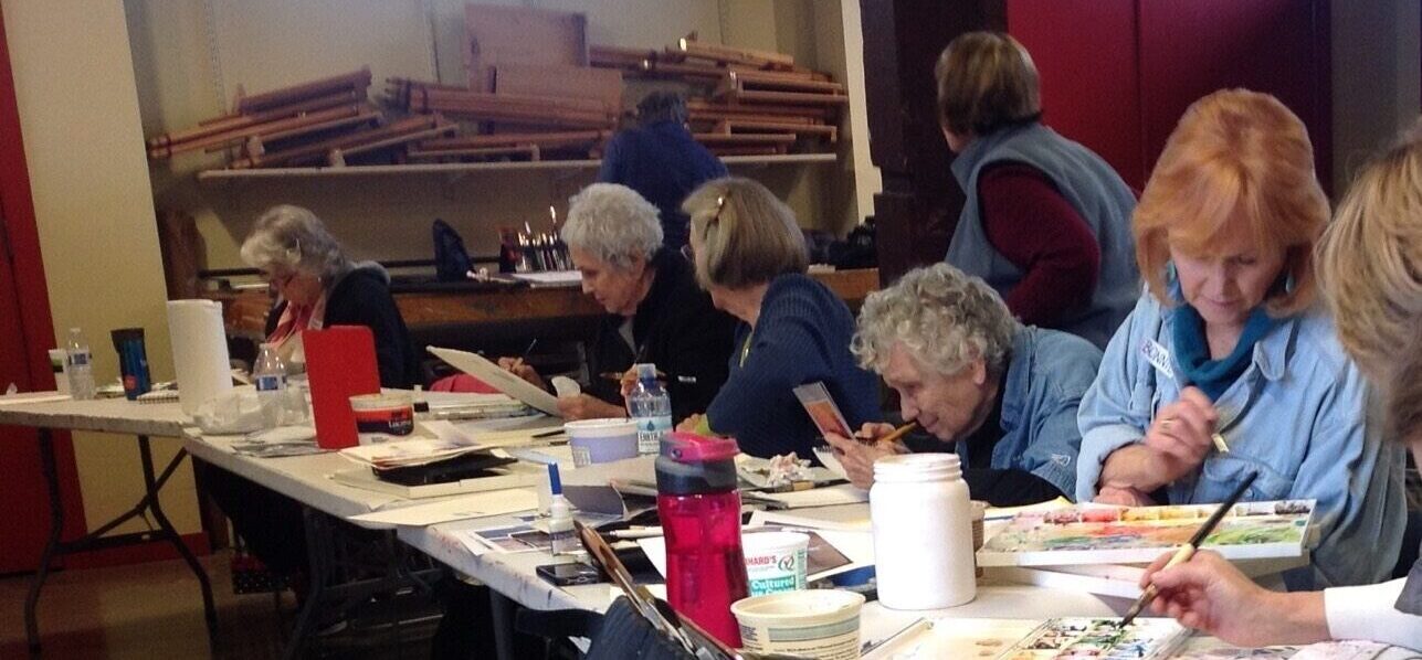 a group of women participating in a water color class