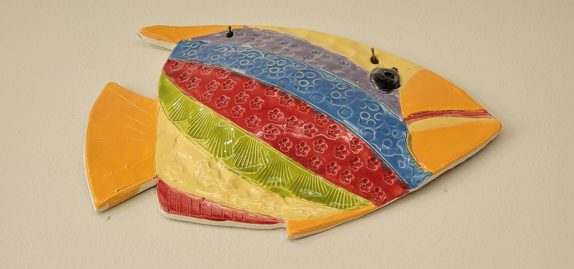 A finished, kiln-dried colorful angel fish with rainbow stripes