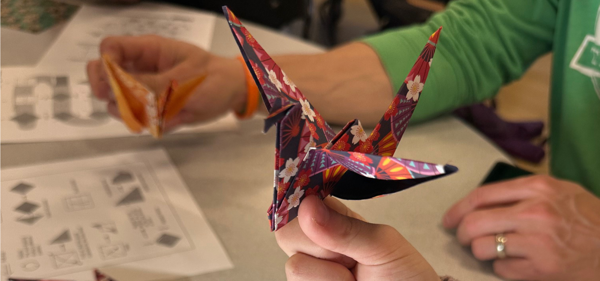 Close-up of hand holding an origami paper crane