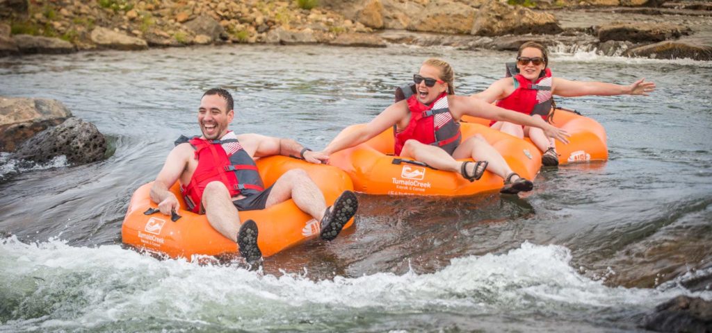 Group on tubes floating through rapids