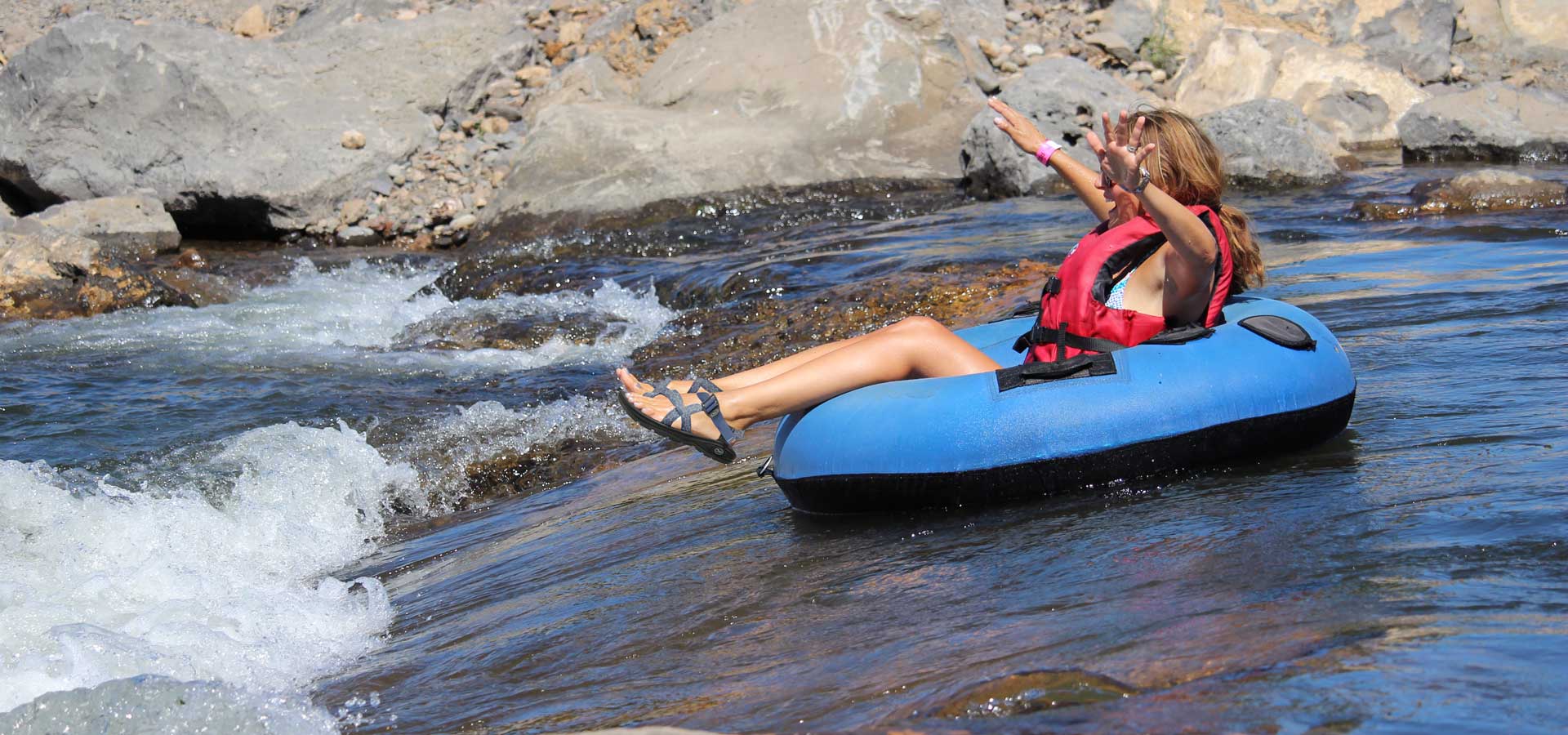 A person going down the ladder, recreational floating channel of the Deschutes River through the Bend Whitewwater Park.