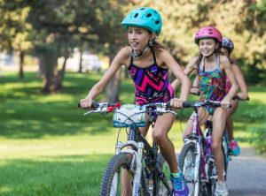 Kids riding bikes as part of a youth triathlon