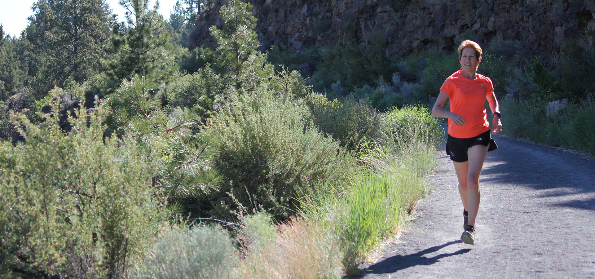 A woman jogging on the Deschutes River Trail on Awbrey Butte.