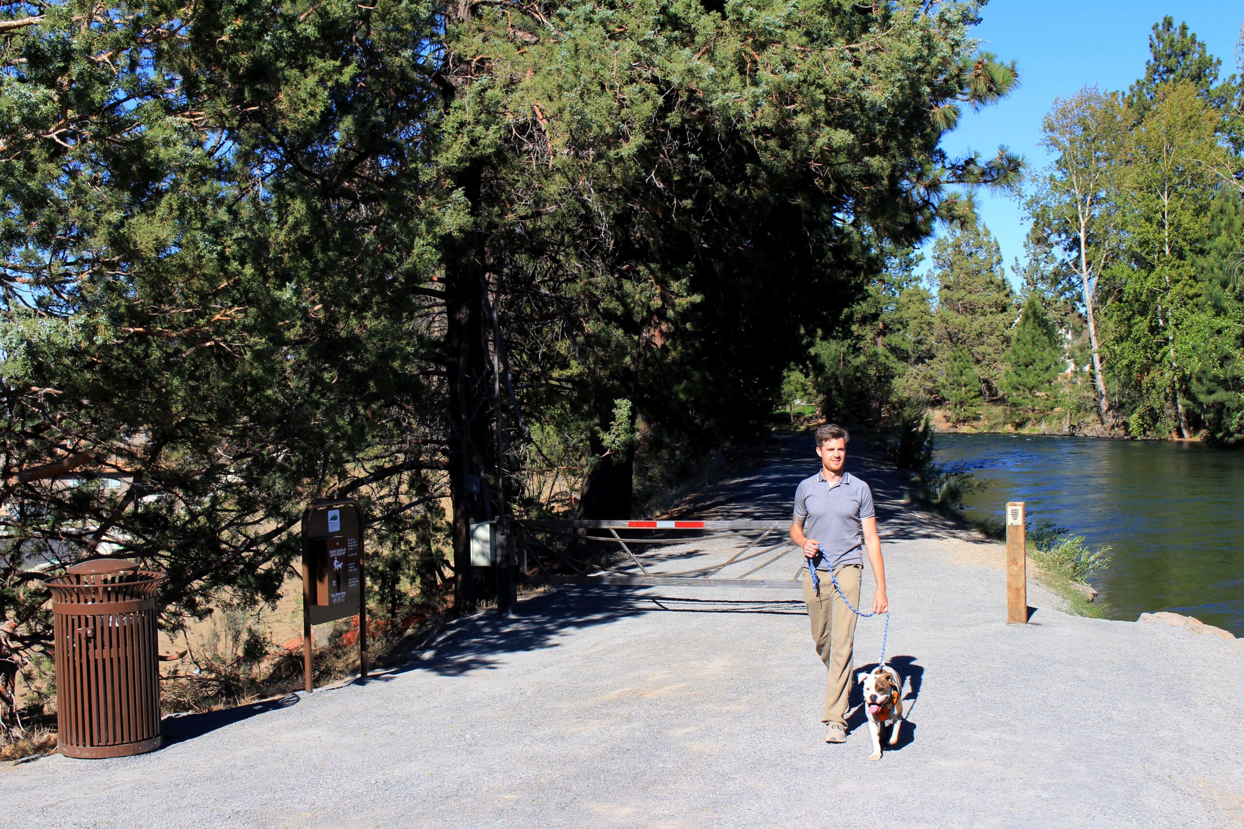 Canal trail with man walking dog