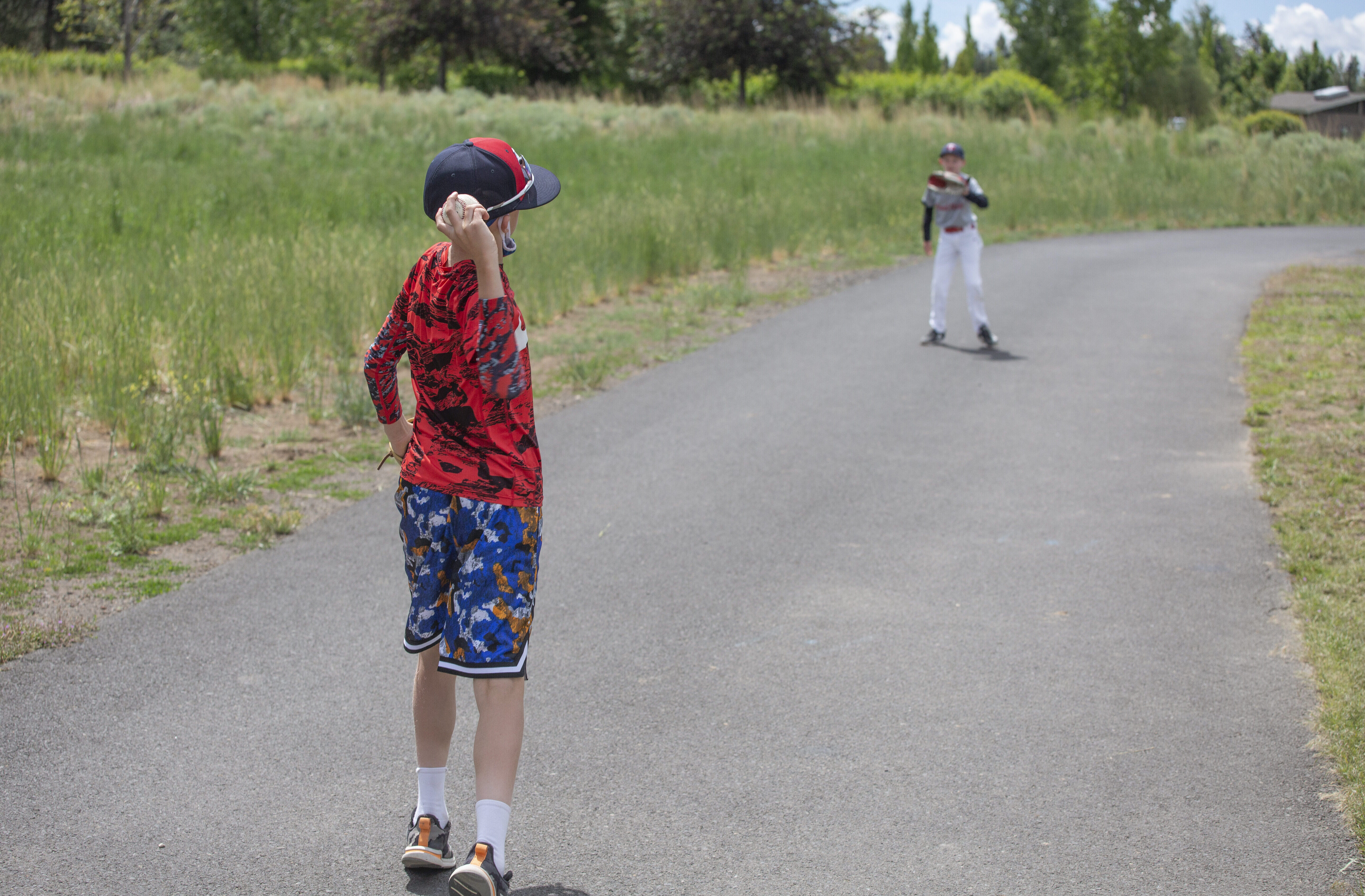 Children palying catch on the pathway at Pine Nursery Park
