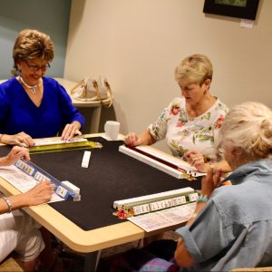 older women playing a board game.