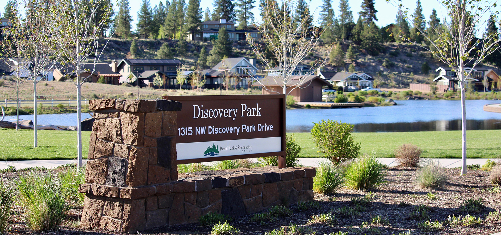 The sign at Discovery Park with the pond in the background.