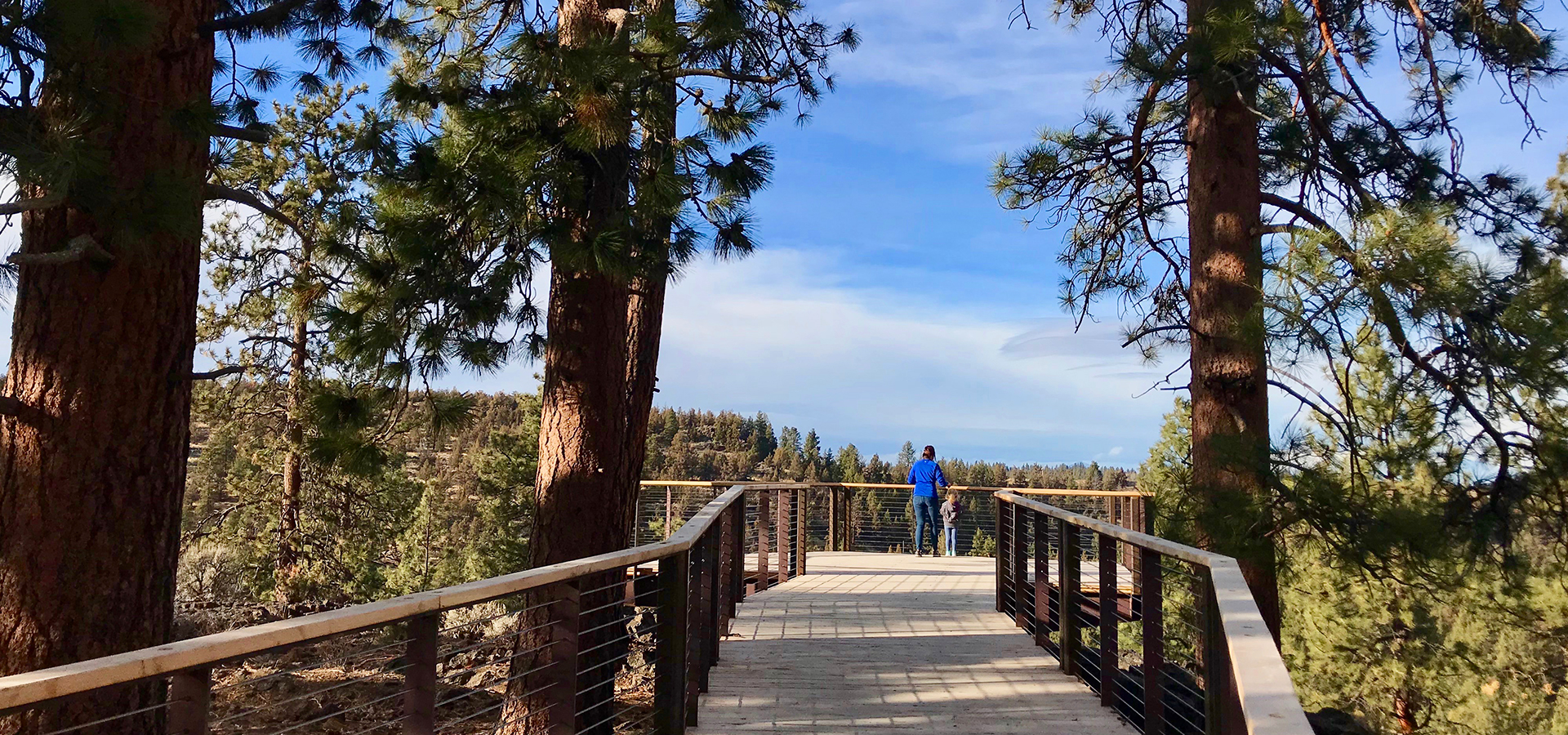 An adult and child on the overlook platform at Riley Ranch.