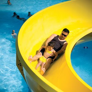 Image of a family on a slide at the Outdoor Activity Pool and Slide at Juniper Swim and Fitness Center in Bend.