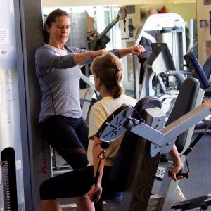 Image of a personal trainer performing individual training in the Fitness Center at Juniper Swim and Fitness Center.