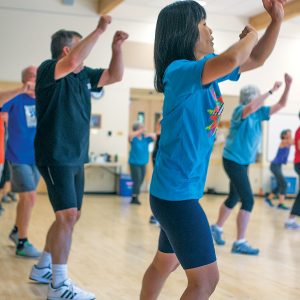 Facility patrons participating in a fitness class for older adults.