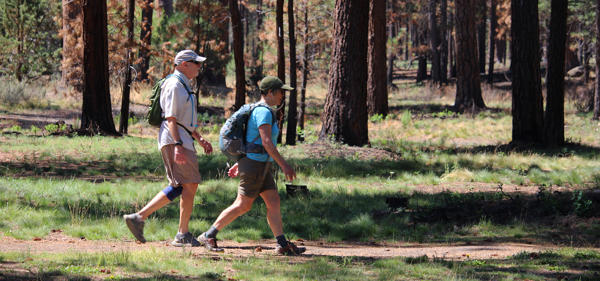 A couple walking on a soft-surface trail through Shevlin Park.