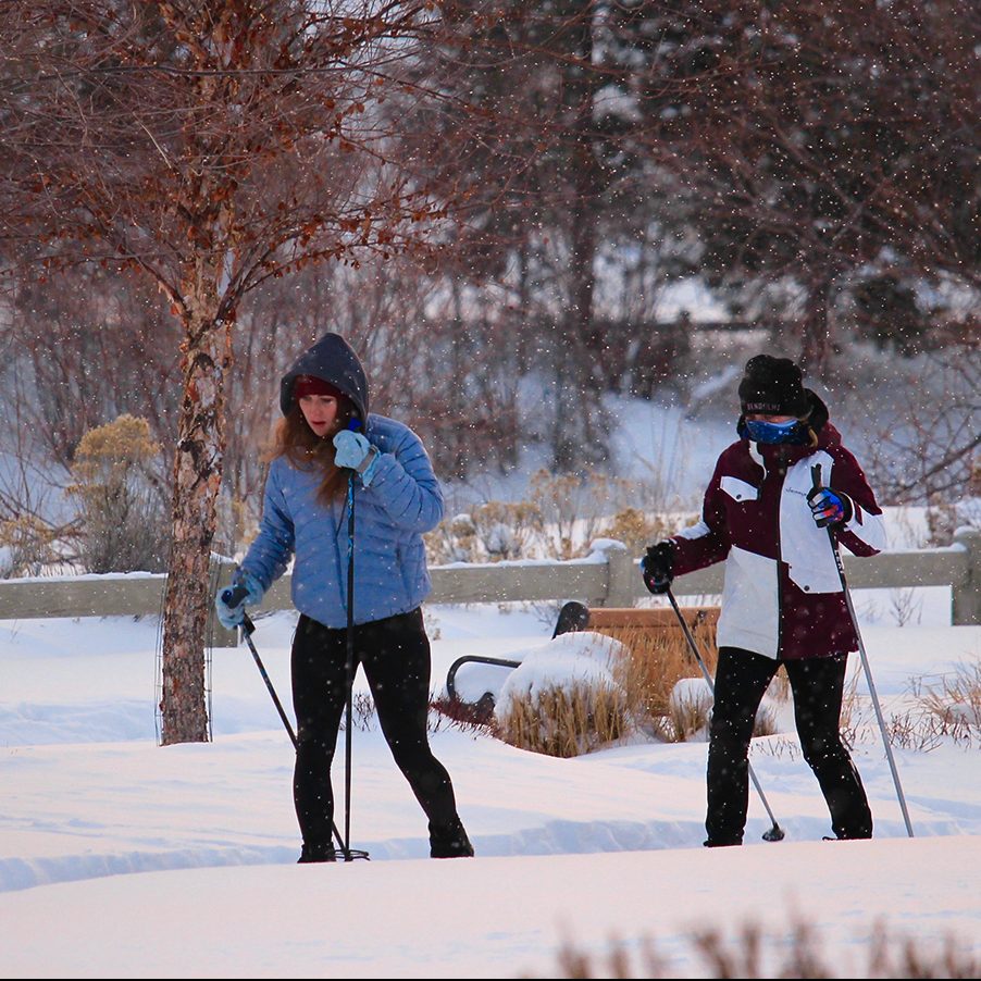 Two women cross country skiing in Riverbend Park.