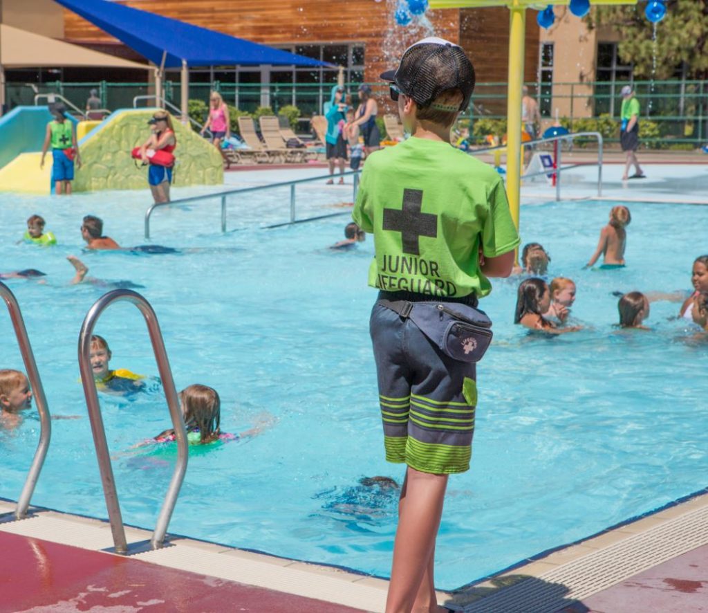 Junior lifeguard volunteer at the outdoor activity pool at Juniper.