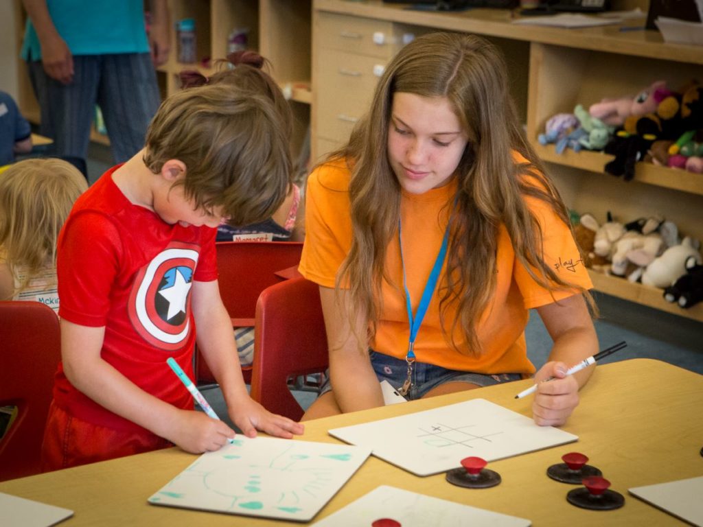 Teen volunteer at Summer Buddies childcare at Juniper.